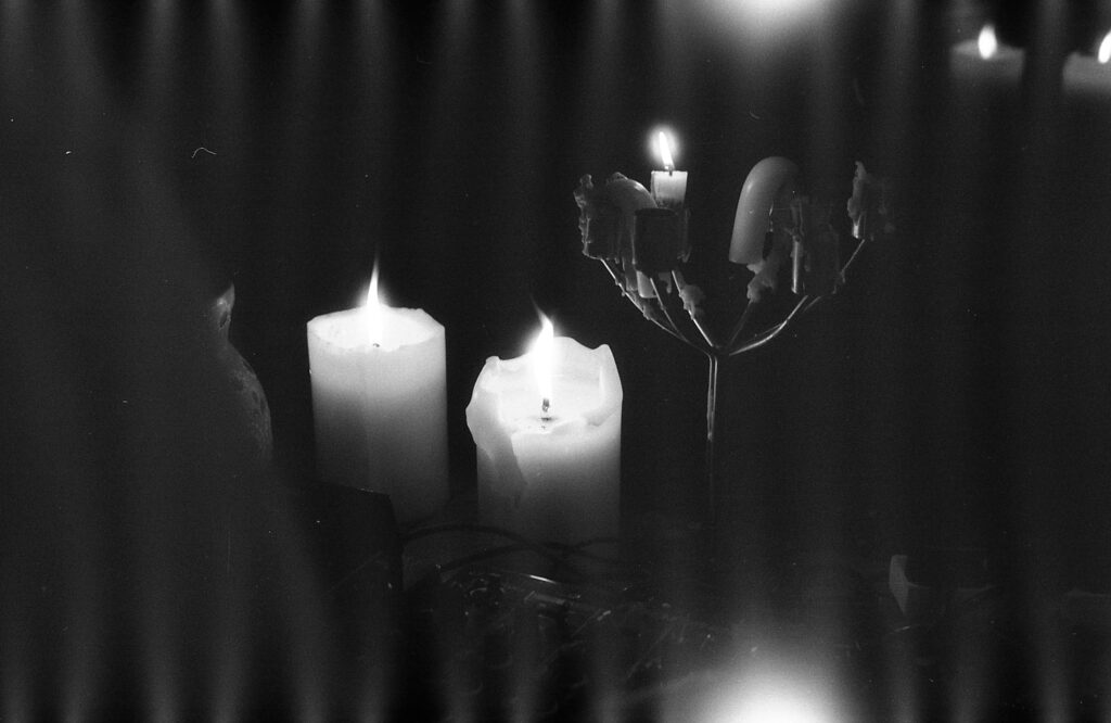 A black and white photo of guttering candles.