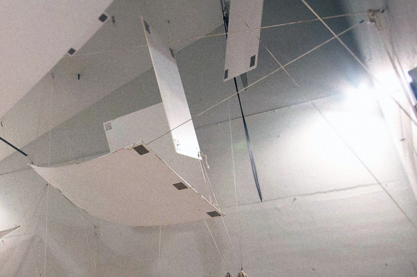 Curved wooden baffles hanging from the ceiling of a reverberation chamber.