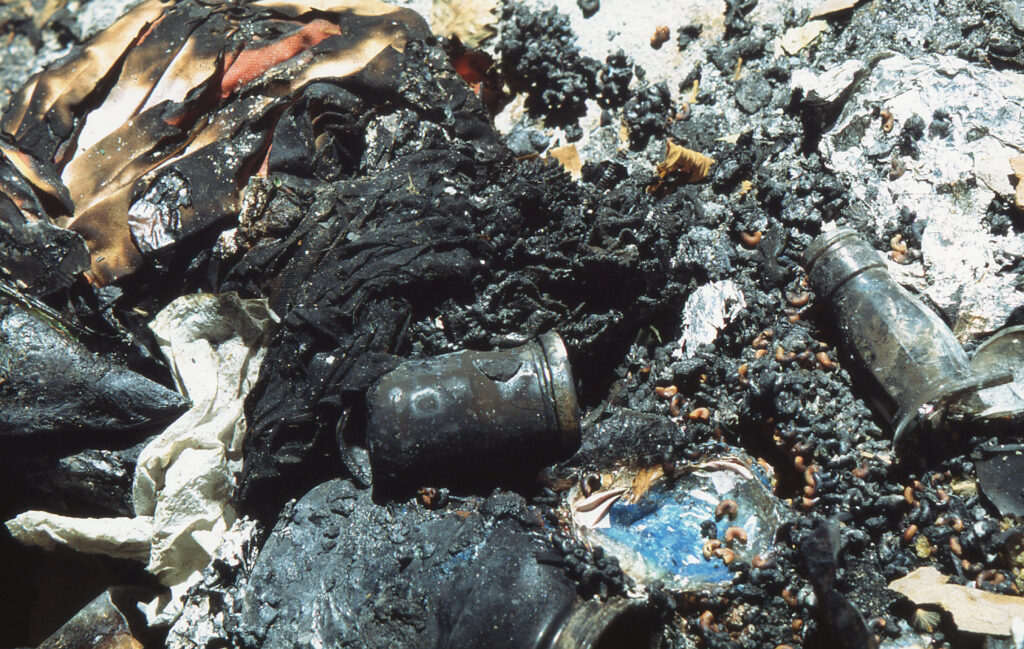A photograph of a pile of burnt rubbish after a riot